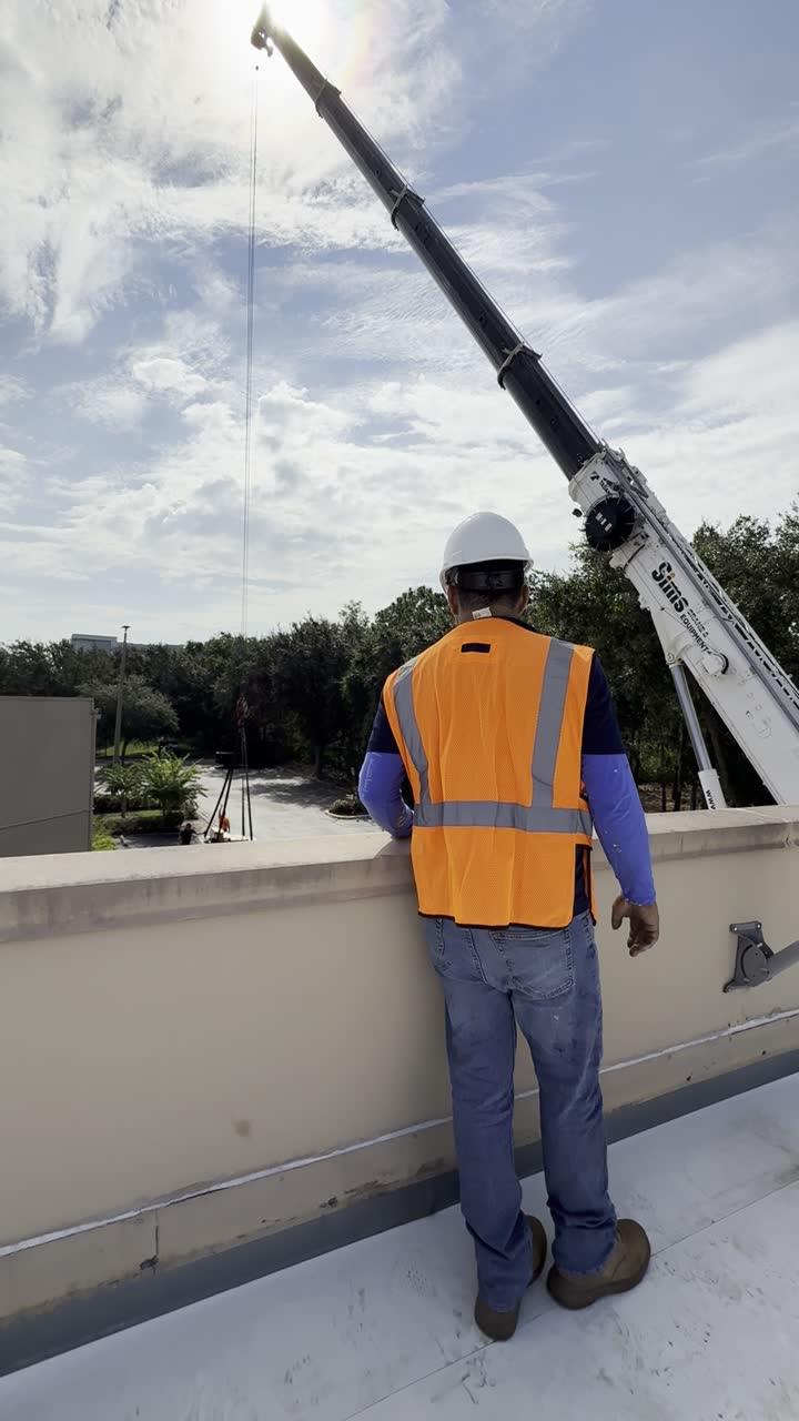 Crane lifting a rooftop unit
